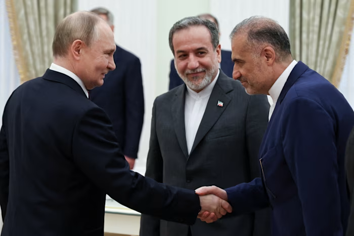 Иран е сключил тайно споразумение с Русия за преносими ракети за 500 млн. евро 2 Vladimir Putin shakes hands with Kazem Jalali as Abbas Araqchi looks on during a meeting at the Kremlin.