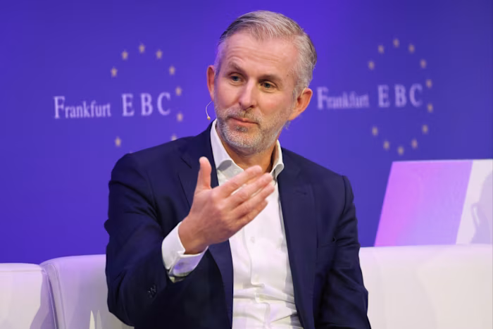 Jan Rinnert gestures while speaking on stage at the Frankfurt European Banking Congress.